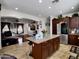 Open kitchen area with stainless steel refrigerator, granite island, and view into the living room at 5255 W Cochise Dr, Glendale, AZ 85302