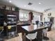 Well lit kitchen with dark cabinetry, stainless steel appliances, and a granite-topped island at 5255 W Cochise Dr, Glendale, AZ 85302