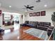 Spacious living room featuring hardwood floors, open archway to the kitchen, and neutral walls at 5255 W Cochise Dr, Glendale, AZ 85302
