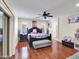Spacious main bedroom featuring hardwood floors, ceiling fan, and dark wood furniture at 5255 W Cochise Dr, Glendale, AZ 85302