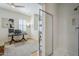 Bathroom with glass shower and hardwood floors plus art in the bedroom area beyond the wall at 615 E Portland St # 160, Phoenix, AZ 85004