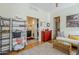 Multipurpose room with a bed, shelf, red dresser, and glimpses of the bathroom and laundry areas at 615 E Portland St # 160, Phoenix, AZ 85004