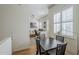 Inviting dining area with open floor plan views of the living room, hardwood floors, and modern lighting fixtures at 615 E Portland St # 160, Phoenix, AZ 85004