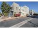 Modern stucco condo building with a small bougainvillea in front and metal fenced courtyard at 615 E Portland St # 160, Phoenix, AZ 85004