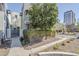 Inviting condo exterior with well-maintained landscaping, mature tree, and easy access to a nearby city street at 615 E Portland St # 160, Phoenix, AZ 85004