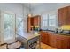 Modern kitchen with stainless steel appliances, dark wood cabinets, ample counter space, and access to an outdoor patio at 615 E Portland St # 160, Phoenix, AZ 85004