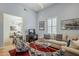 Cozy living room showcasing hardwood floors, comfortable seating, modern decor, and a view into the dining area at 615 E Portland St # 160, Phoenix, AZ 85004