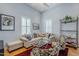 Bright living room with hardwood floors, neutral-colored furniture, plantation shutters, and stylish decor at 615 E Portland St # 160, Phoenix, AZ 85004