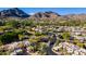 Scenic aerial view of a community nestled in the mountains with lush landscaping, mature trees, and well-maintained streets at 6229 N 30Th Way, Phoenix, AZ 85016