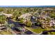 High-angle aerial shot of a community featuring a golf course, pool, tennis courts, mature trees, and gated entry at 6229 N 30Th Way, Phoenix, AZ 85016
