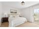 Cozy bedroom with a queen-sized bed, neutral tones, and a balcony access at 6229 N 30Th Way, Phoenix, AZ 85016