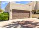 Spacious two-car garage featuring a large, modern door, set in a well-maintained exterior with desert landscaping at 6229 N 30Th Way, Phoenix, AZ 85016