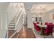 Bright hallway showcasing hardwood floors, elegant staircase, and an open view into the dining area at 6229 N 30Th Way, Phoenix, AZ 85016