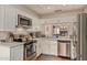 A charming kitchen with white cabinets, stainless steel appliances, and granite countertops at 6229 N 30Th Way, Phoenix, AZ 85016