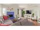Comfortable living room with a striking blue fireplace and a large television at 6229 N 30Th Way, Phoenix, AZ 85016