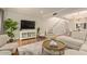 Bright living room featuring hardwood floors, a staircase, and a large-screen television at 6229 N 30Th Way, Phoenix, AZ 85016