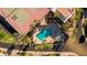 Aerial view of a sparkling blue pool, tennis courts and lush, tropical landscaping for resort-style living at 6229 N 30Th Way, Phoenix, AZ 85016