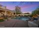 Backyard oasis features a beautiful pool with a rock waterfall, outdoor kitchen, and seating areas at 7501 E Phantom Way, Scottsdale, AZ 85255