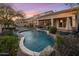 Inviting backyard features a sparkling pool, lush landscaping, and an outdoor entertaining area at 7501 E Phantom Way, Scottsdale, AZ 85255