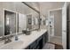 Bright bathroom features a dual sink vanity with stylish fixtures and a large mirror at 7501 E Phantom Way, Scottsdale, AZ 85255