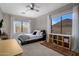 Bright bedroom featuring an area rug, large window, and an open shelving unit at 7501 E Phantom Way, Scottsdale, AZ 85255