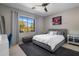 Bright bedroom with large window, plush rug, and neutral colored walls and decor at 7501 E Phantom Way, Scottsdale, AZ 85255