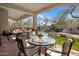 Covered patio overlooking the pool features comfortable seating and views of the lush backyard at 7501 E Phantom Way, Scottsdale, AZ 85255