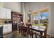 Bright dining room with modern light fixture, built-in bar, and large windows at 7501 E Phantom Way, Scottsdale, AZ 85255