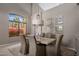 Elegant dining room with vaulted ceiling, designer light fixture, and neutral decor at 7501 E Phantom Way, Scottsdale, AZ 85255