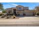 Charming two-story home with desert landscaping, a three-car garage, and an American flag at 7501 E Phantom Way, Scottsdale, AZ 85255