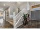 Grand foyer featuring slate tile flooring, staircase, and an elegant chandelier near the entryway at 7501 E Phantom Way, Scottsdale, AZ 85255