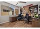Dedicated office space with built in cabinets, wood flooring, and a bright window at 7501 E Phantom Way, Scottsdale, AZ 85255