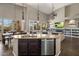 Open-concept kitchen with granite counters, center island, and view into the living room at 7501 E Phantom Way, Scottsdale, AZ 85255