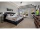 Spacious main bedroom boasting tray ceilings, French doors to the pool, and plush carpet at 7501 E Phantom Way, Scottsdale, AZ 85255