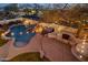 Aerial view of a backyard oasis featuring a sparkling pool, spa, lush landscaping, and built-in grill at 7501 E Phantom Way, Scottsdale, AZ 85255