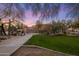 Manicured lawn and desert landscaping surround a walkway, creating an inviting approach to the property at 7501 E Phantom Way, Scottsdale, AZ 85255