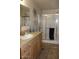 Bathroom featuring granite counters, framed mirror and shower with sliding doors at 7807 E Main St # F24, Mesa, AZ 85207