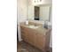 Bathroom featuring granite counters, framed mirror and wood cabinets at 7807 E Main St # F24, Mesa, AZ 85207