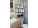 Bathroom featuring a tub/shower combo with patterned curtain and shelving at 7807 E Main St # F24, Mesa, AZ 85207