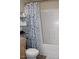 Bathroom featuring a tub/shower combo with patterned curtain and shelving at 7807 E Main St # F24, Mesa, AZ 85207