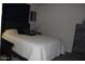 Cozy bedroom with queen-sized bed and dark furnishings at 7807 E Main St # F24, Mesa, AZ 85207
