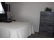 Bedroom featuring a decorative black pillow and a matching dresser with a houseplant at 7807 E Main St # F24, Mesa, AZ 85207