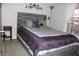 Bedroom featuring a decorative headboard, large window and small bedside table at 7807 E Main St # F24, Mesa, AZ 85207