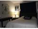 Bedroom featuring a decorative black pillow and a matching dresser with a houseplant at 7807 E Main St # F24, Mesa, AZ 85207