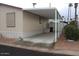 Exterior view of a home with a covered carport and landscaped front at 7807 E Main St # F24, Mesa, AZ 85207