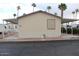 Mobile home featuring dual carports and low-maintenance landscaping at 7807 E Main St # F24, Mesa, AZ 85207