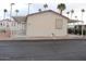 Tan home with awning and landscaping with palm trees in background at 7807 E Main St # F24, Mesa, AZ 85207