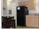 Kitchen featuring a black refrigerator, cabinets, and an eat-in dining area at 7807 E Main St # F24, Mesa, AZ 85207