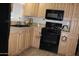 Eat-in kitchen features modern appliances and light wood cabinets at 7807 E Main St # F24, Mesa, AZ 85207