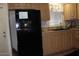 Kitchen featuring cabinets and a black refrigerator at 7807 E Main St # F24, Mesa, AZ 85207